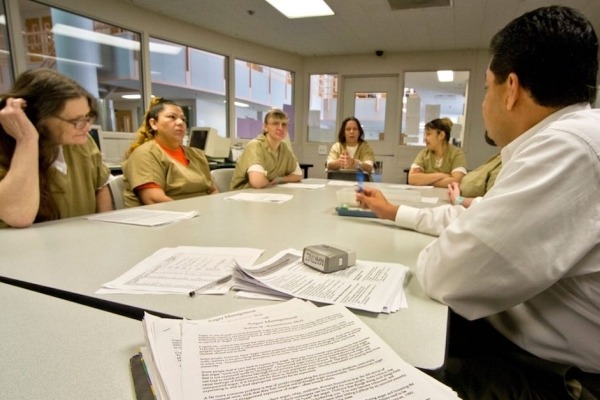 Uniformed women in a jail participate in a drug treatment seminar in Santa Ana, CA.