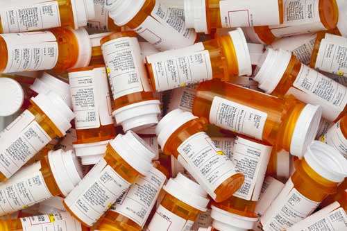 Dozens of prescription medicine bottles in a jumble